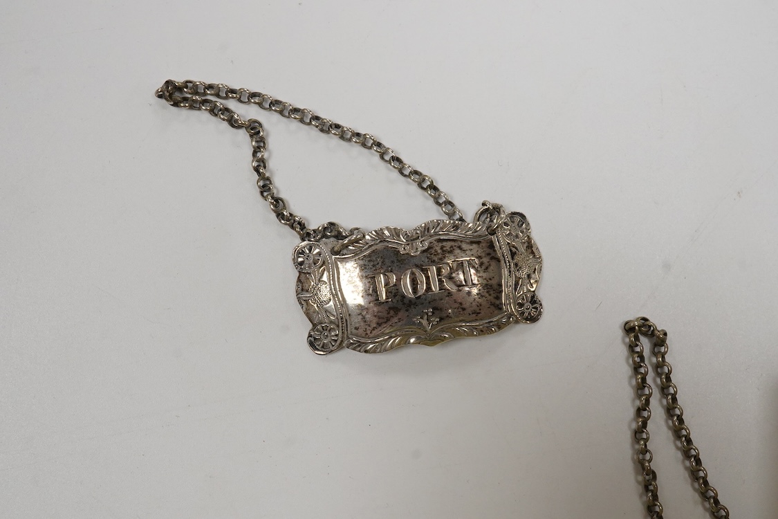 Four silver napkin rings including a pair, Sheffield, 1919, together with two George III silver wine labels, Claret, maker probably Abstinando King and Port, maker James Phipps I.